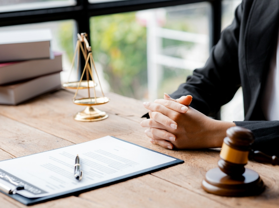 A woman lawyer sits in the office of her law firm.