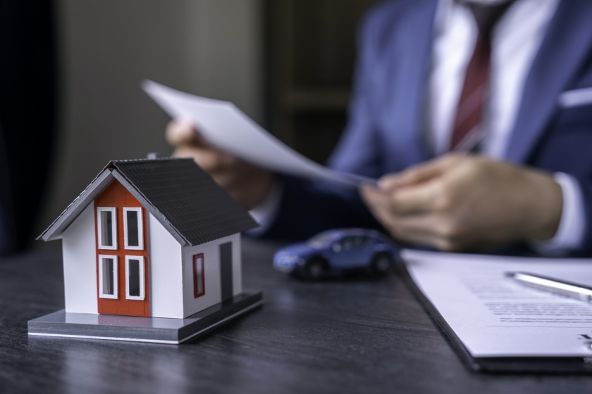 Businessman reading contract documents for purchase and home insurance home insurance concept, home