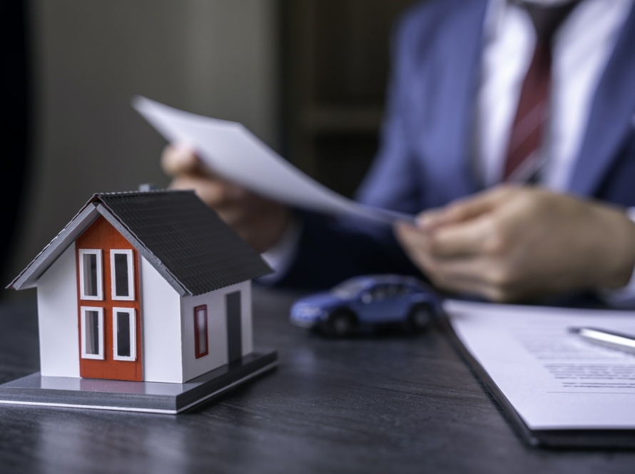 Businessman reading contract documents for purchase and home insurance home insurance concept, home