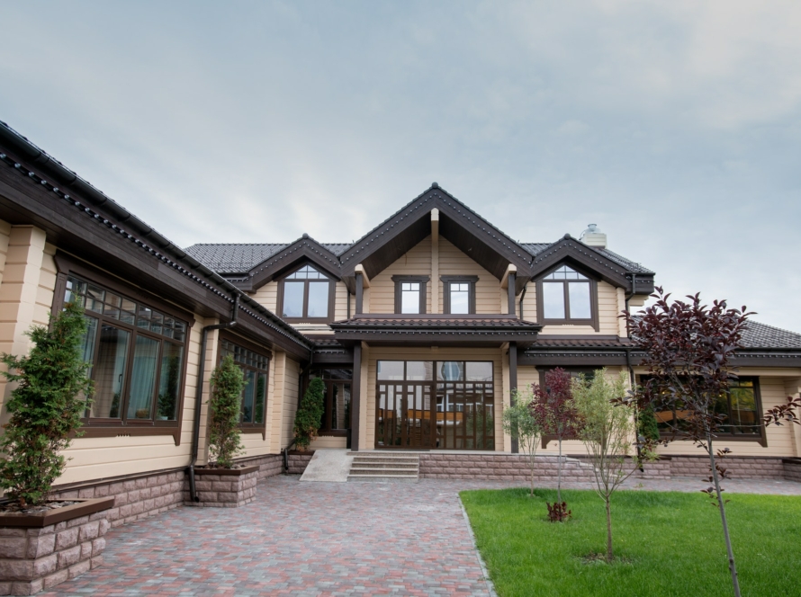 Exterior of modern comfortable cottage or house with front yard