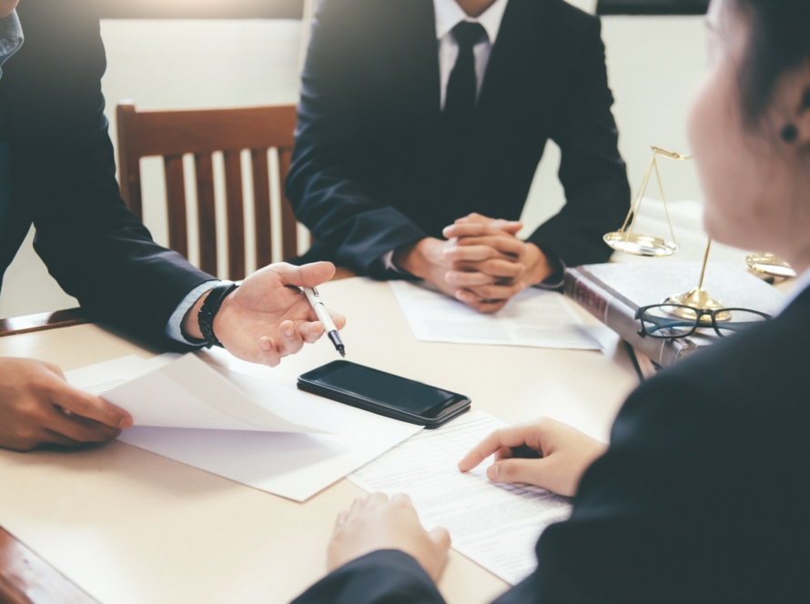 Lawyer and attorney having team meeting at law firm.