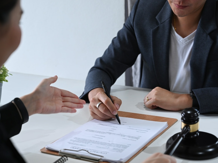 Shot of lawyer or attorney explaining terms, condition on legal document.